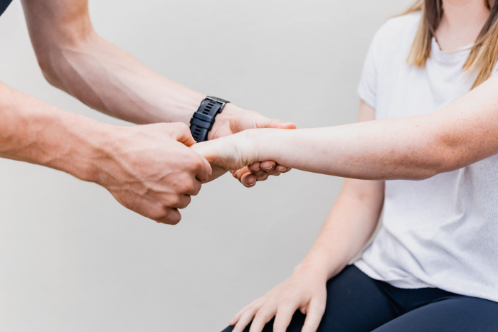 Image of physiotherapist assessing patients wrist